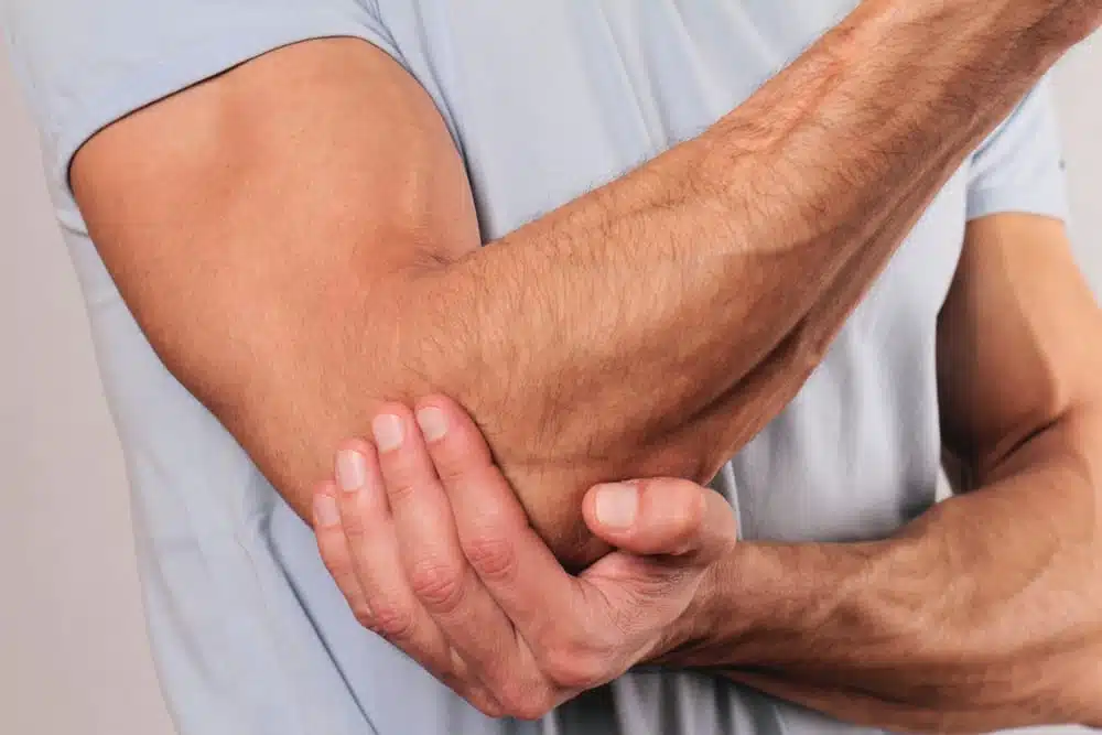 Man experiencing pain in the inner elbow