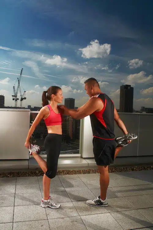 man and woman exercising to help enhance strength and flexibility