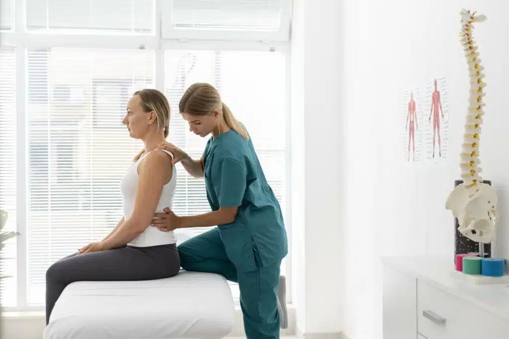 Chiropractor screening a patient for possible Scoliosis  session.