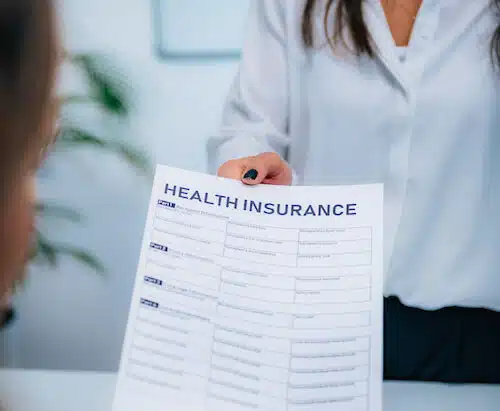 specialist handing over Health Insurance Claim Form to patient